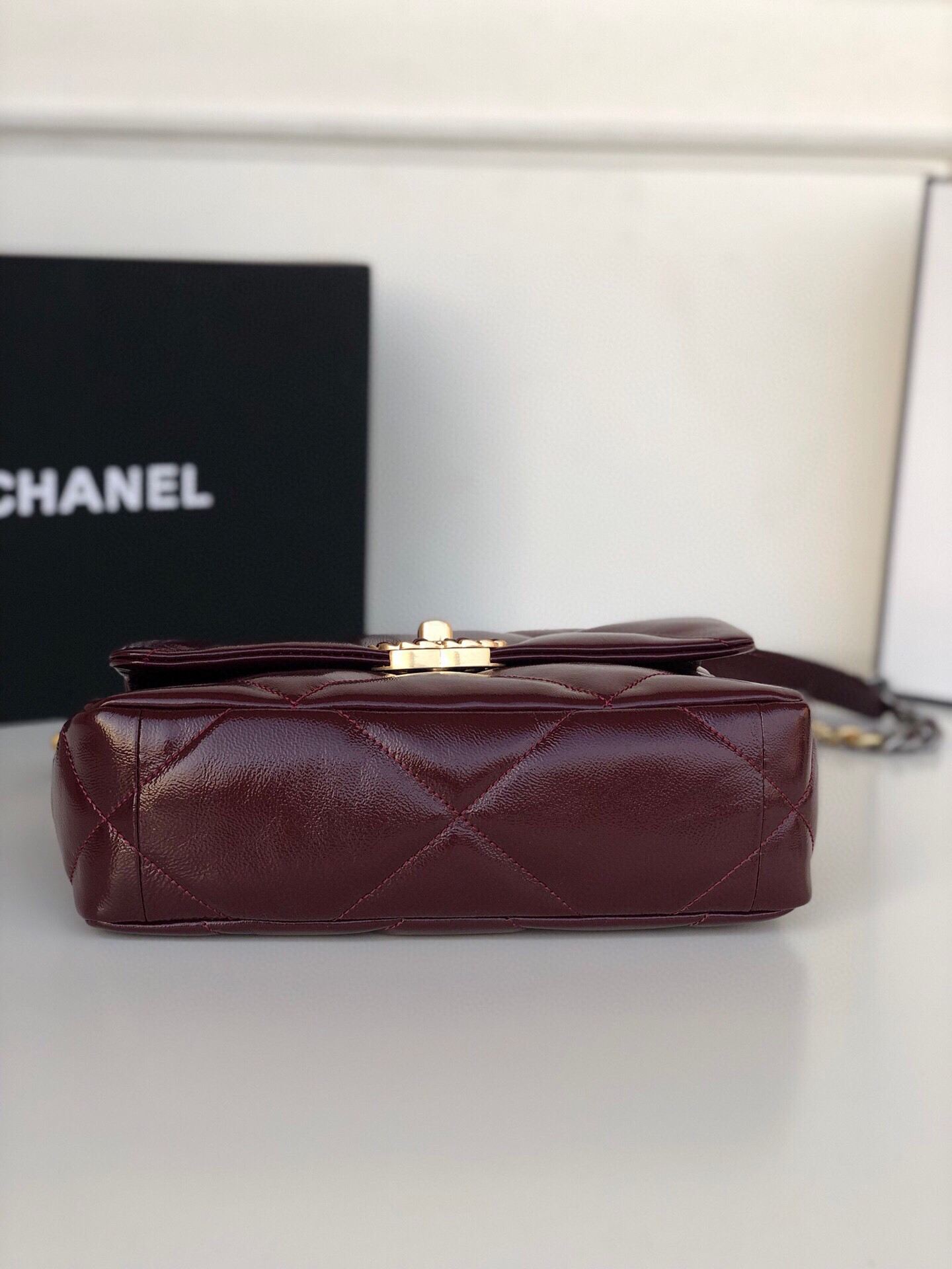 Ch*el 19 handbag shiny leather, gold-tone, silver-tone & ruthenium-finish metal dark red 6.2 × 10.1 × 3.5 in